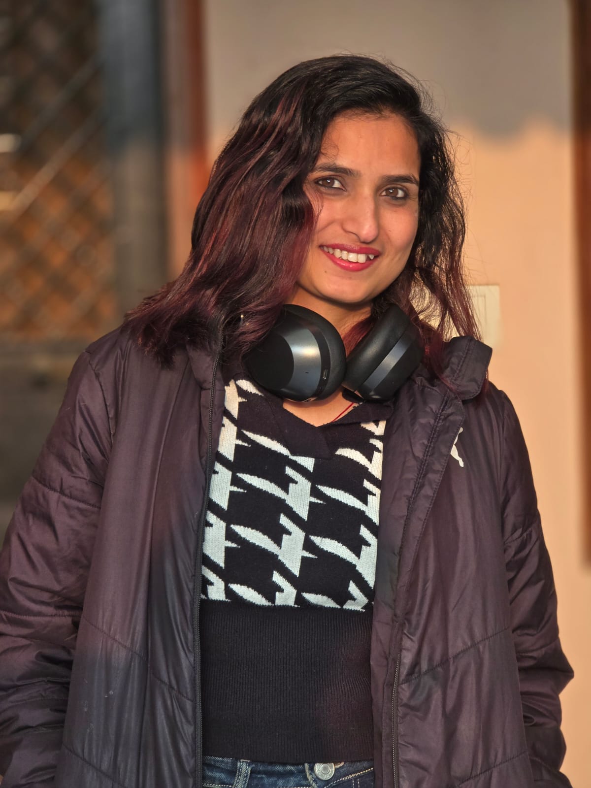 Winter casual — serene sideways gaze, houndstooth sweater, warm light